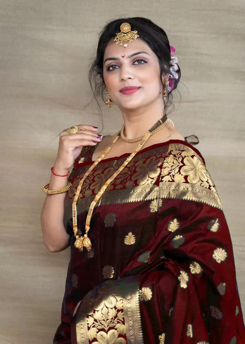 Woman wearing Royal Maroon Banarasi Silk Saree with gold zari work and traditional jewellery
